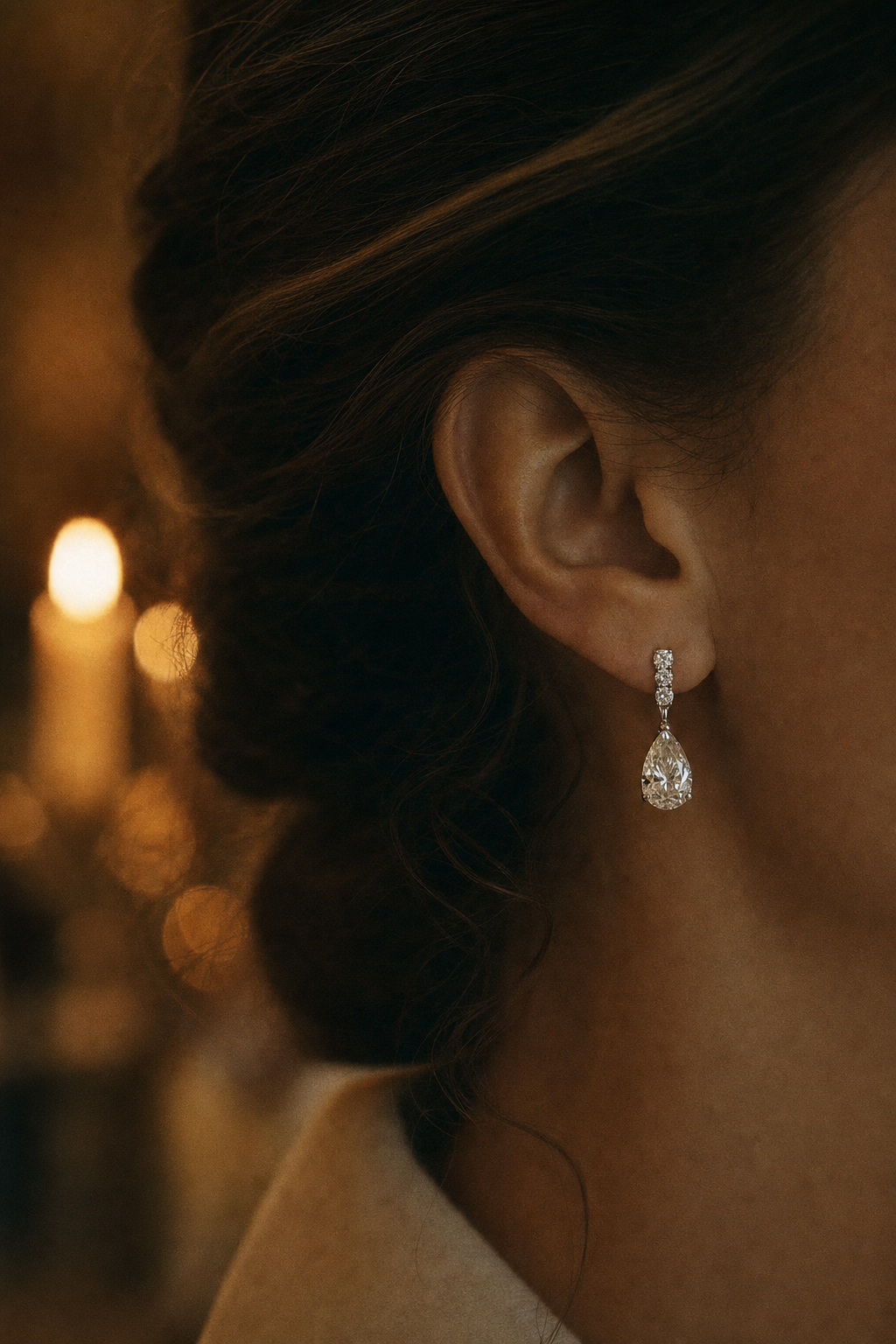 editorial portrait — woman laughing in candlelight, diamond drops