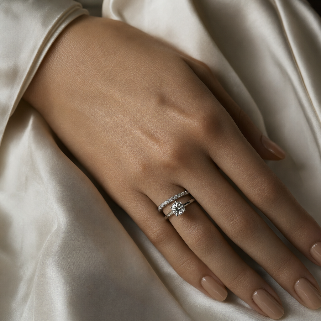 hand wearing a classic round brilliant diamond solitaire ring in platinum
